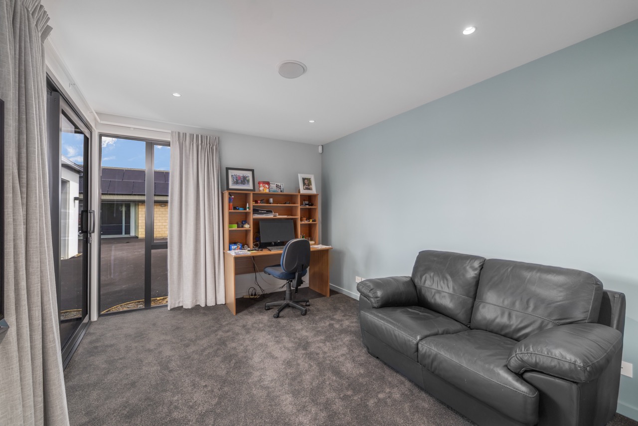 Study room with blue-grey walls and sliding door