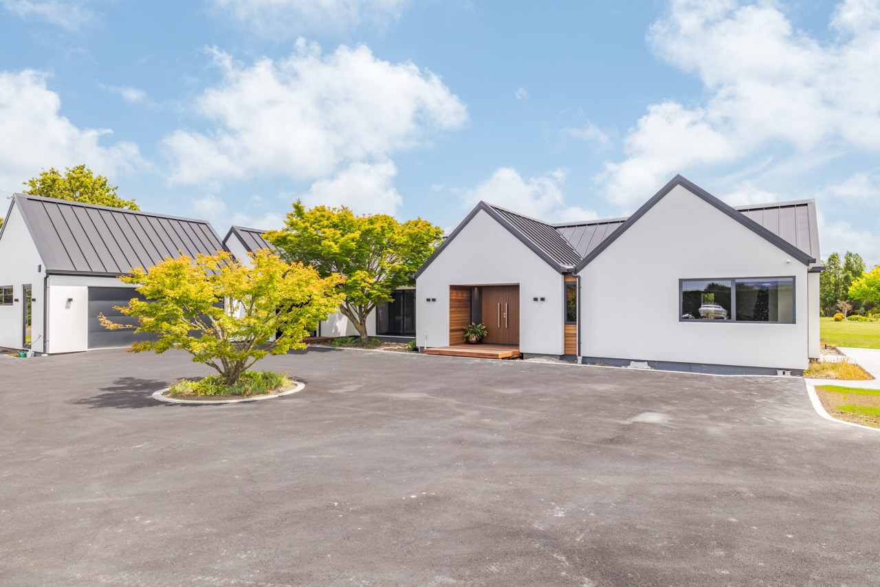 Front exterior with feature tree and detached garage