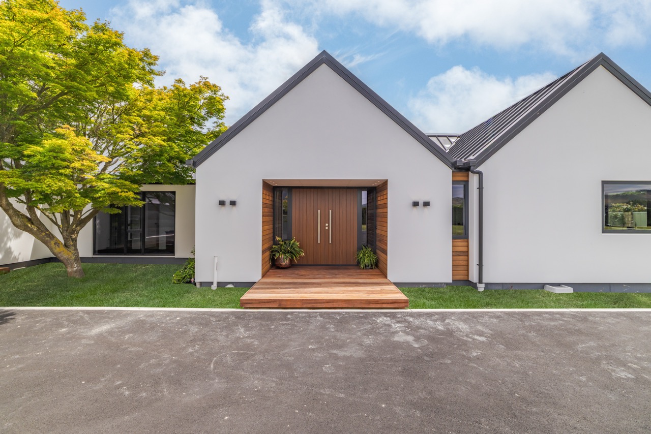 Front entrance close-up with cedar portal and timber deck