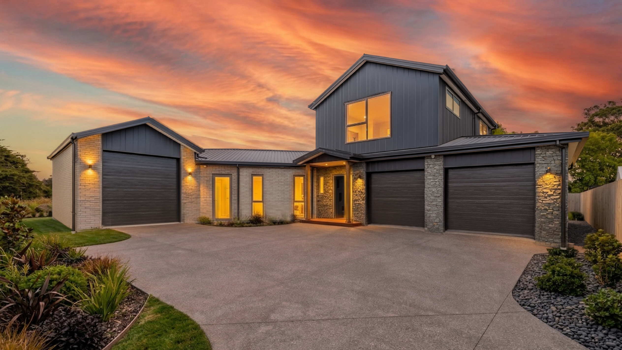 Kahurangi Road — two-storey Burness Homes new build at twilight with warm interior glow