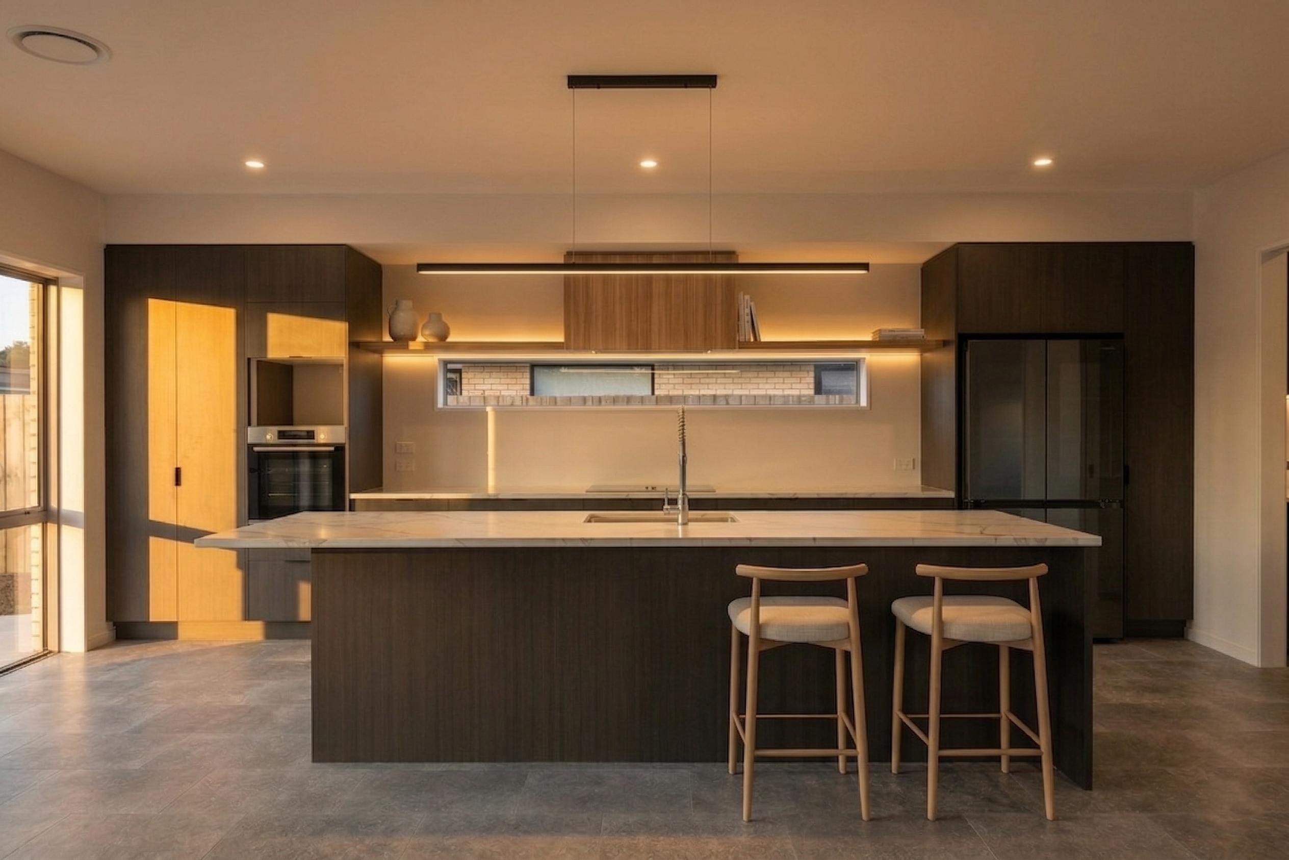 Kahurangi Road — bespoke dark kitchen with marble island and timber bar stools