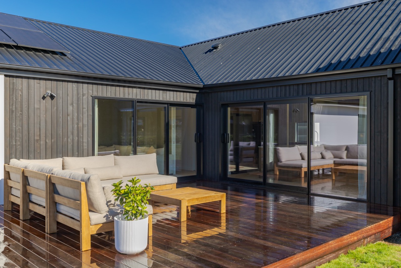 Courtyard from another angle — sliding doors on three aspects opening onto hardwood deck